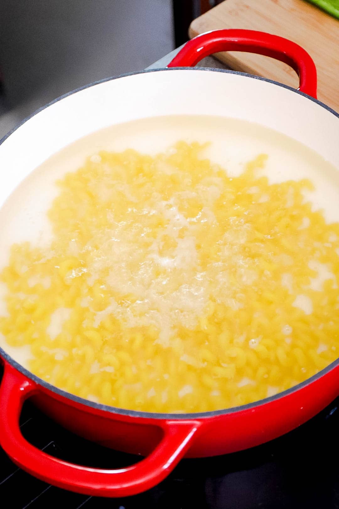 Pasta boiling in water in a large pot.