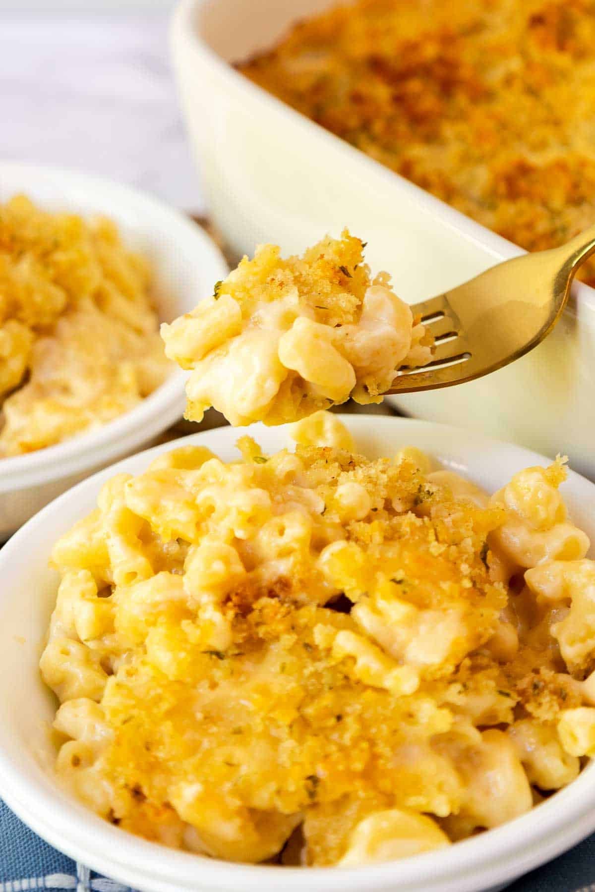 Forkful of gouda mac and cheese from a small bowl.