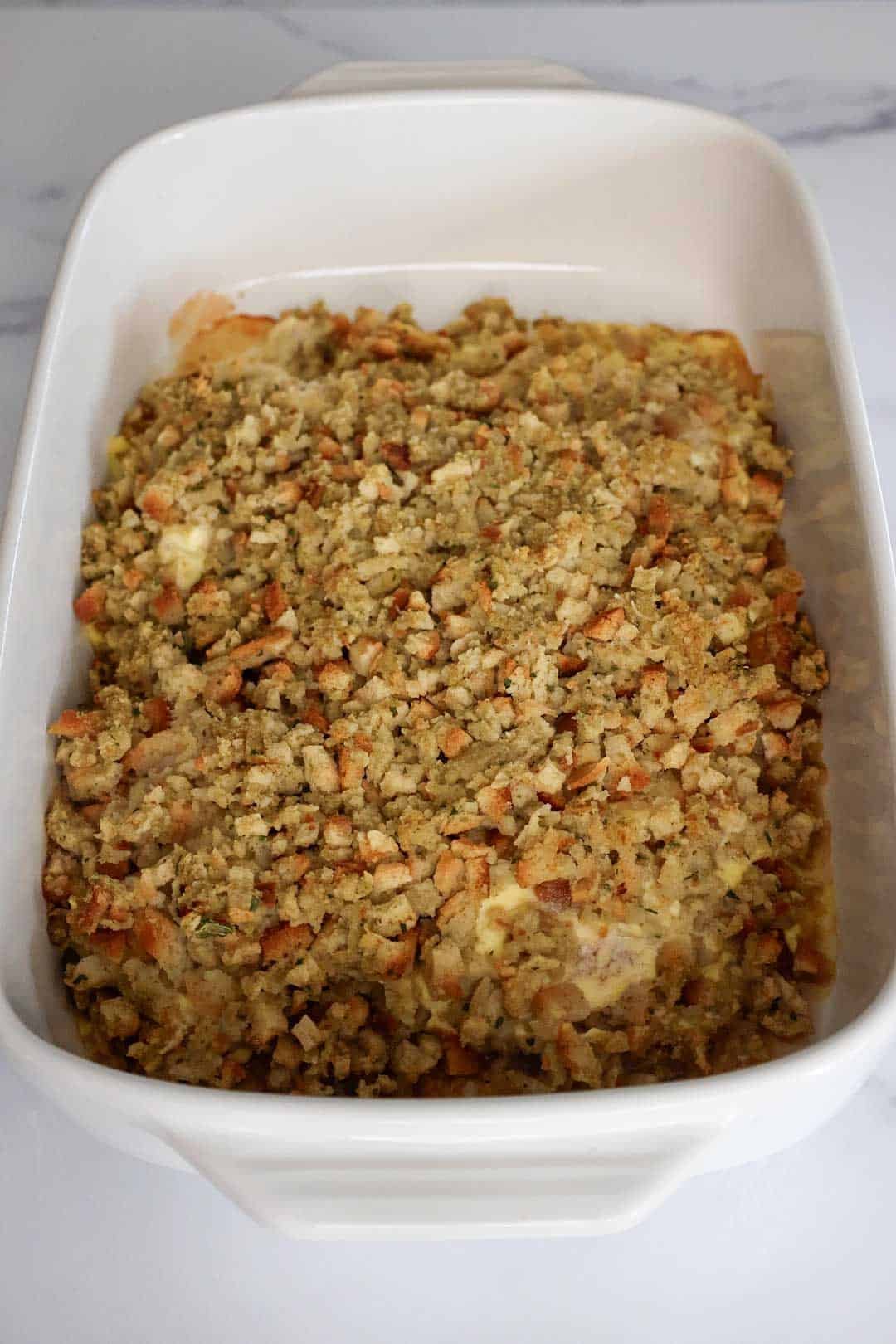 The final baked pork chops and stuffing dish, golden and crisp on top, fresh out of the oven.