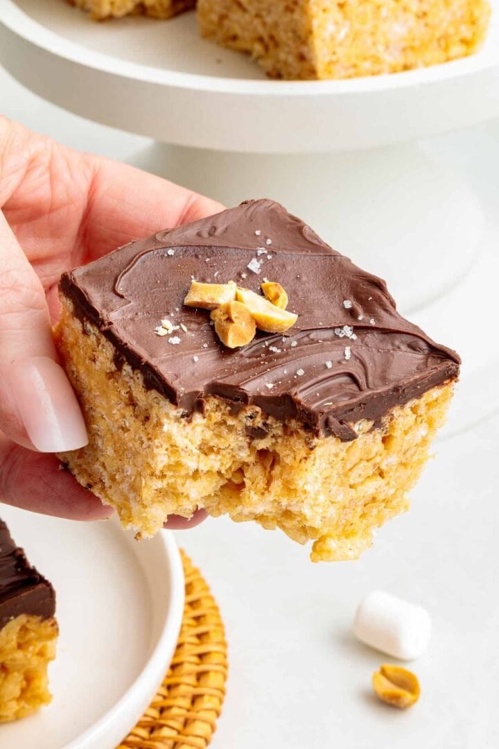 A bite taken out of a chocolate peanut butter Rice Krispie treat.