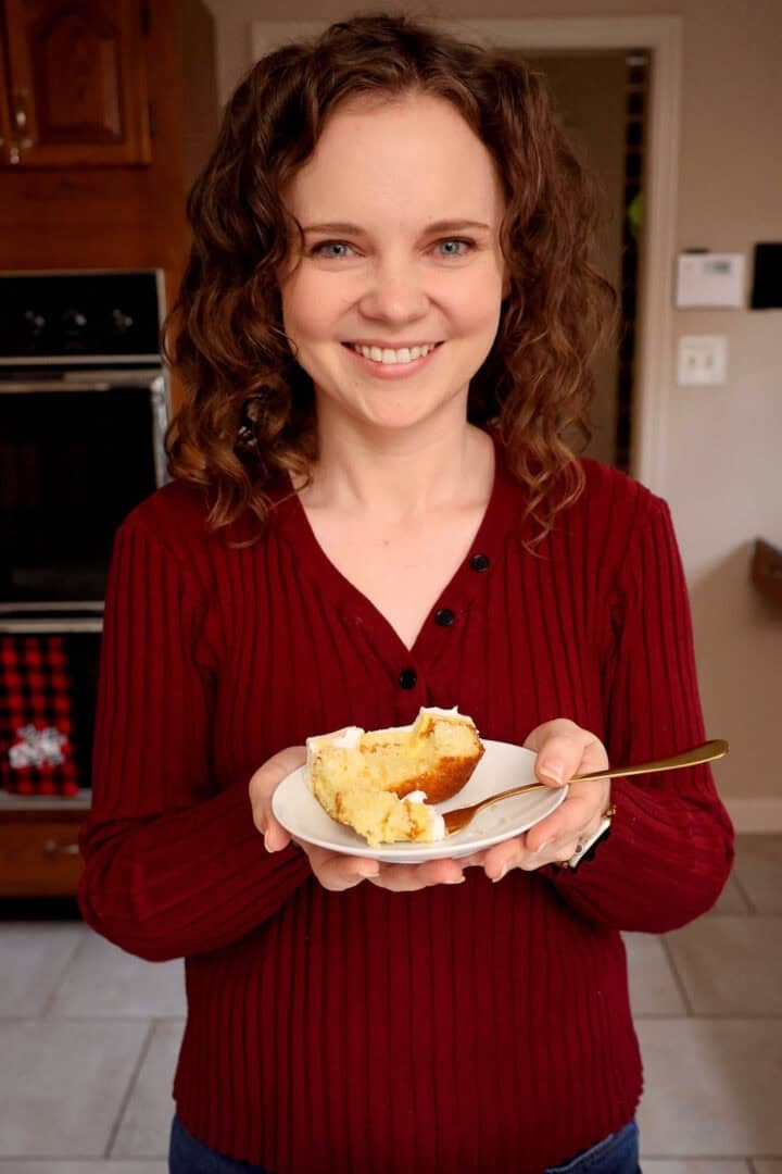 Kelsey Smith holding a plate of eggnog poke cake.