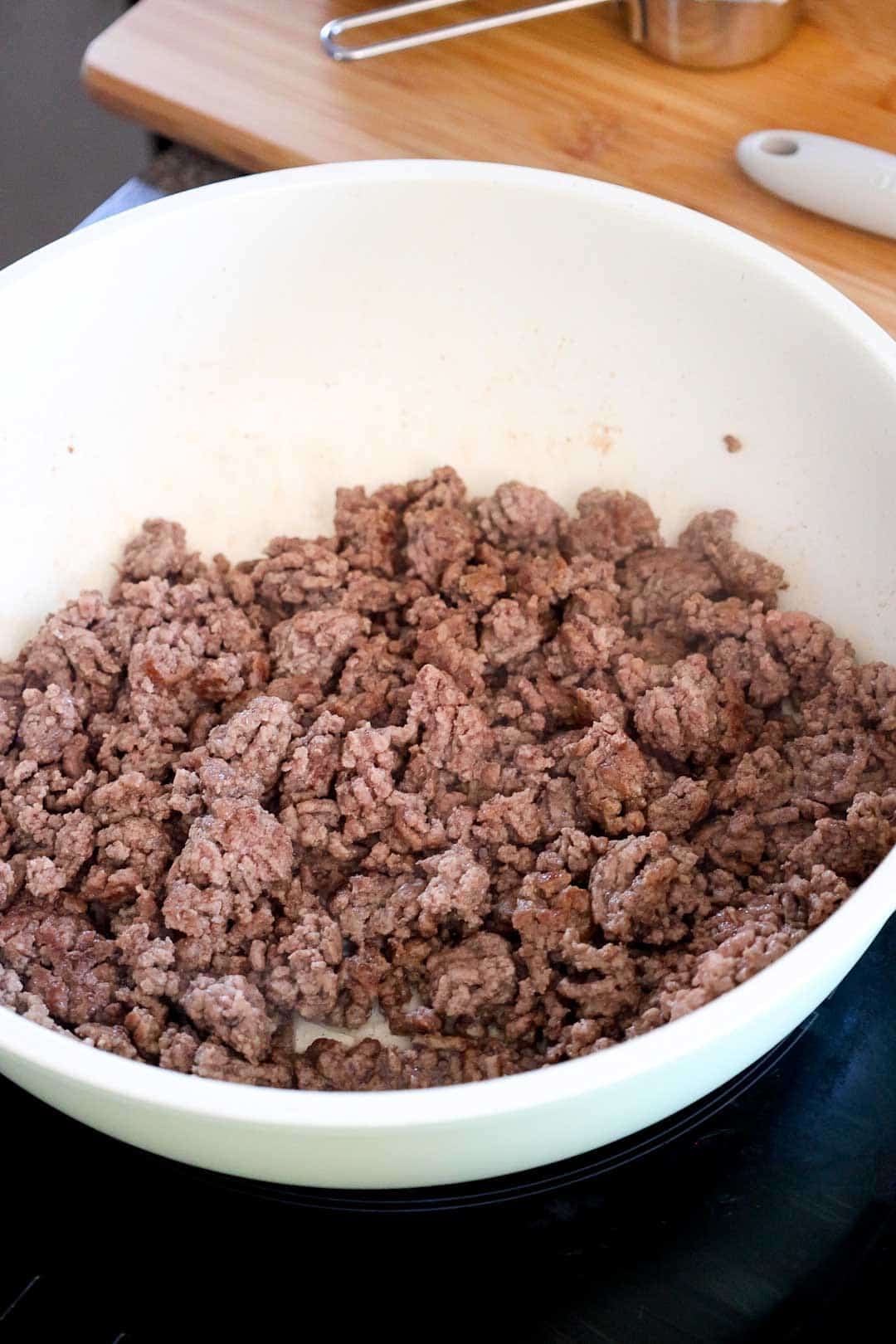 Ground beef browning in a skillet as the first step in making taco mac and cheese.