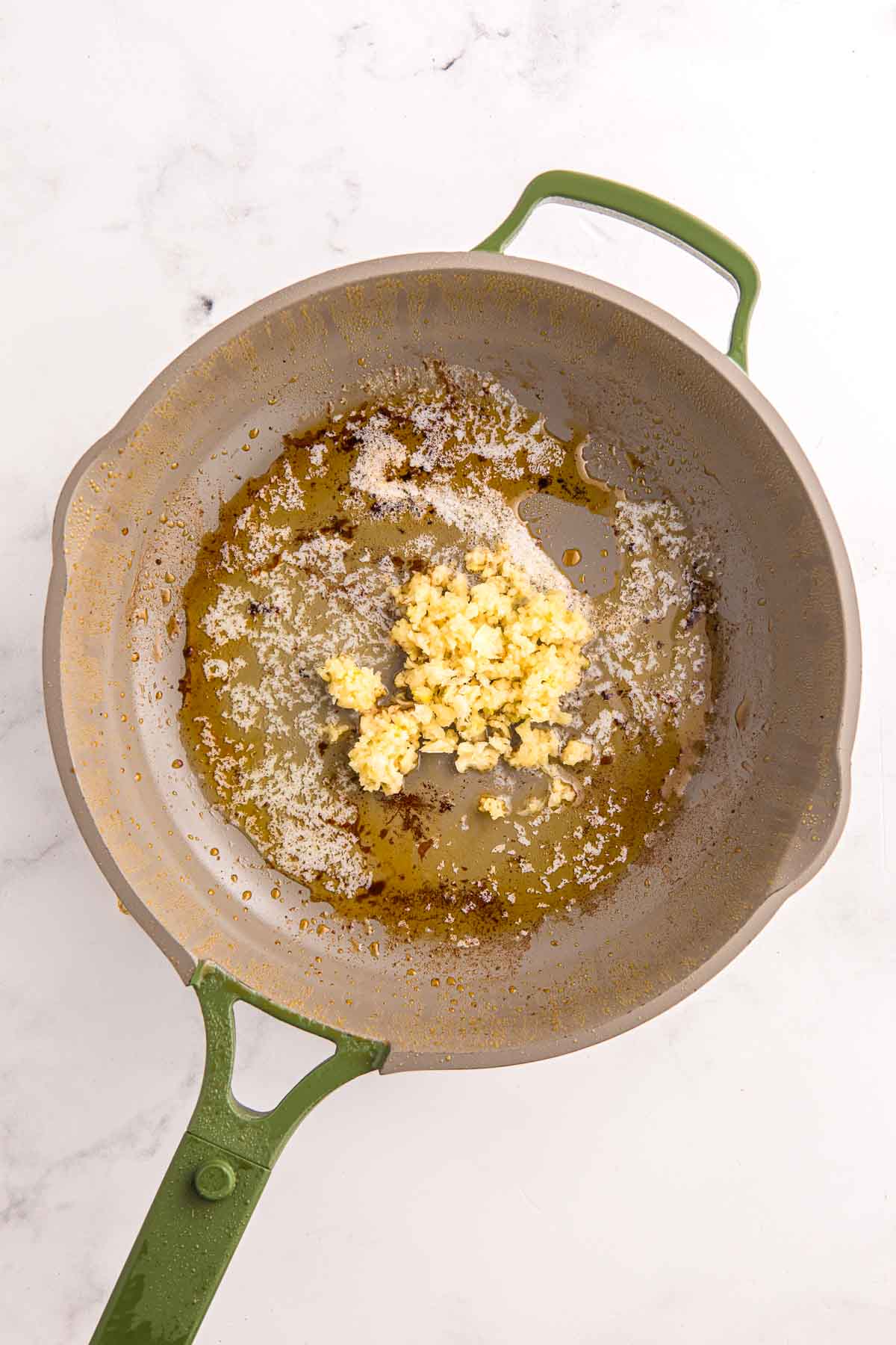 Minced garlic cooking in butter and oil in a skillet. Base for the creamy garlic sauce.