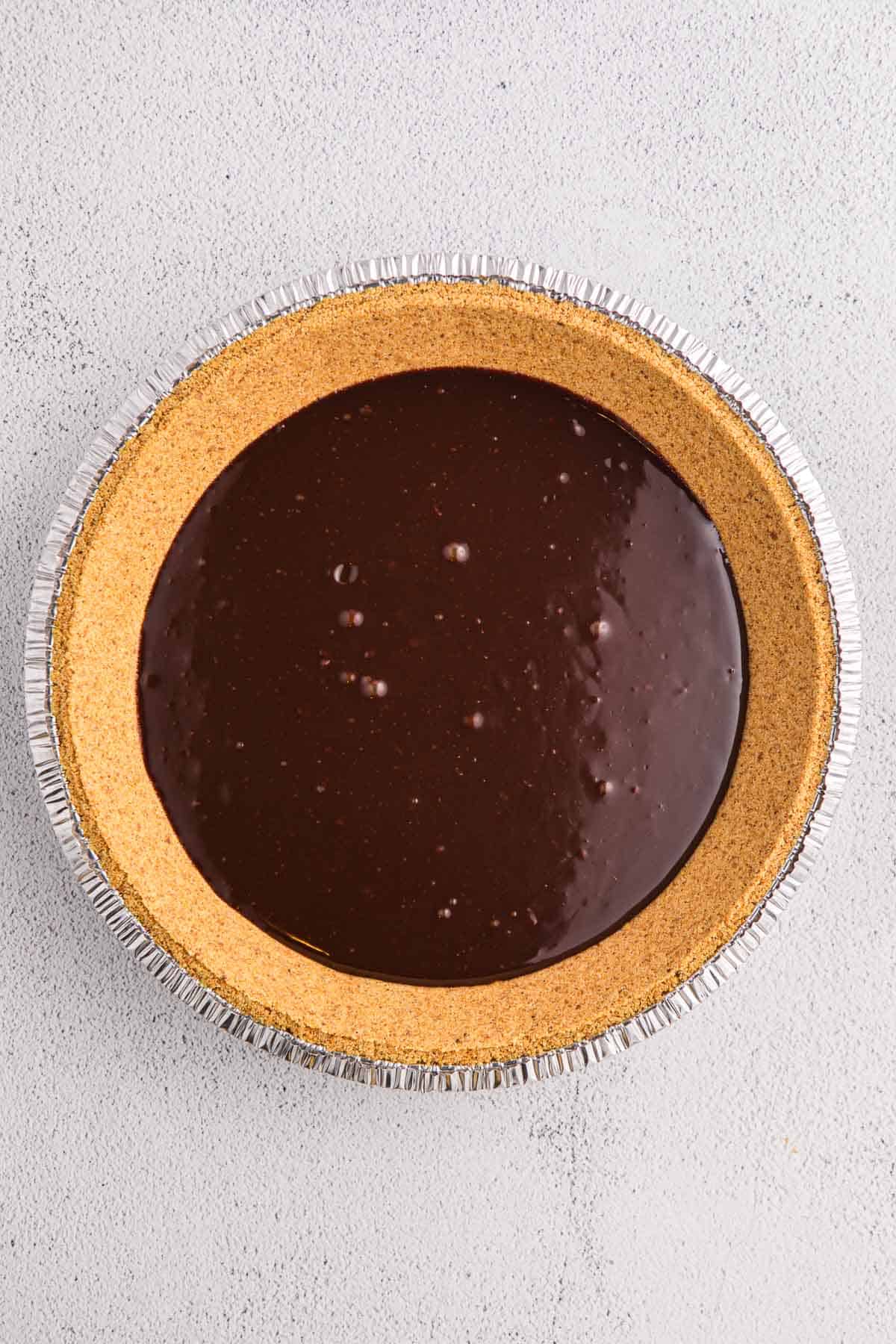 Graham cracker pie crust filled with a layer of chocolate.