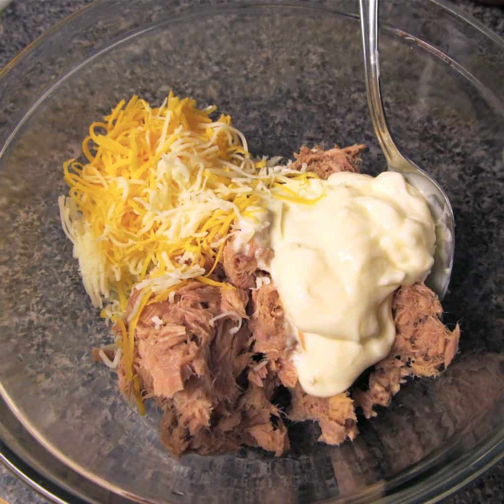 Tuna, mayo, and cheese in a bowl.