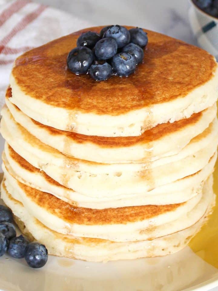 Vegan Bisquick Pancakes topped with blueberries and syrup.