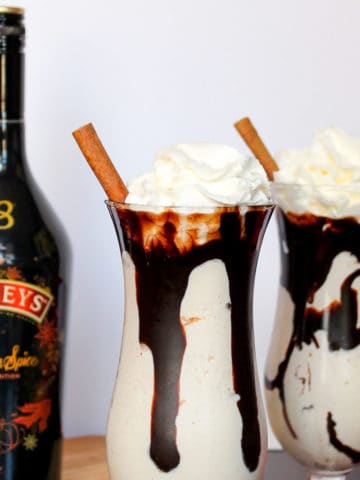 Baileys Pumpkin Spice Mudslide topped with whipped cream and a cinnamon stick.