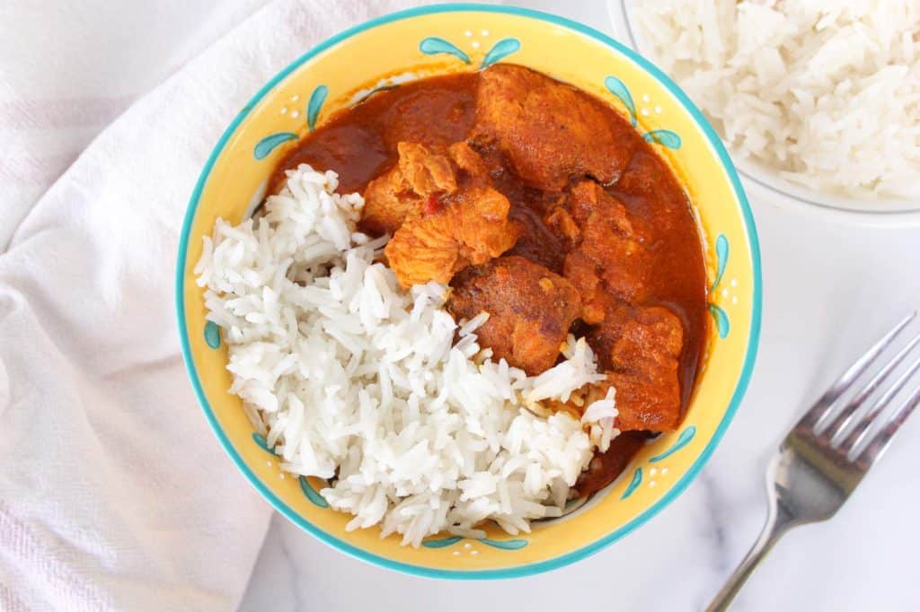 Chicken tikka masala and rice in a bowl.