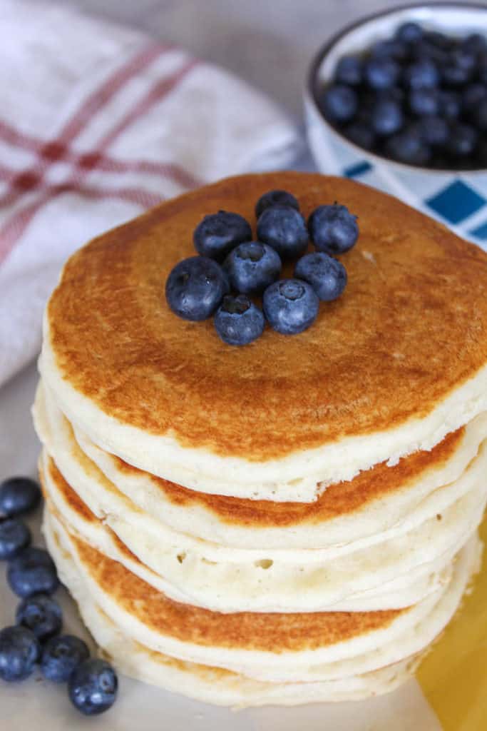 Stack of Vegan Bisquick Pancakes topped with blueberries.