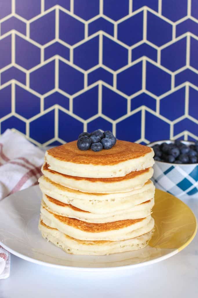 Stack of vegan Bisquick pancakes topped with blueberries.