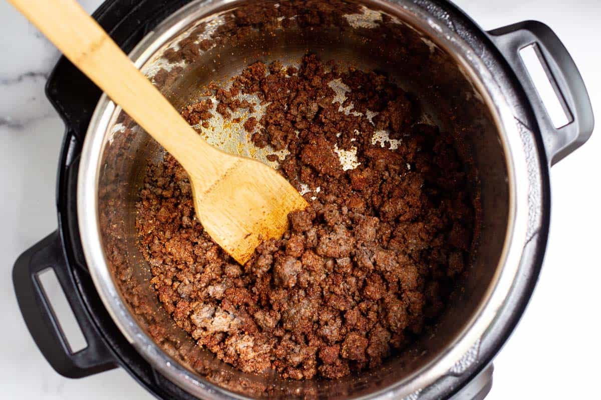 Ground beef coated in seasoning in the Instant Pot.