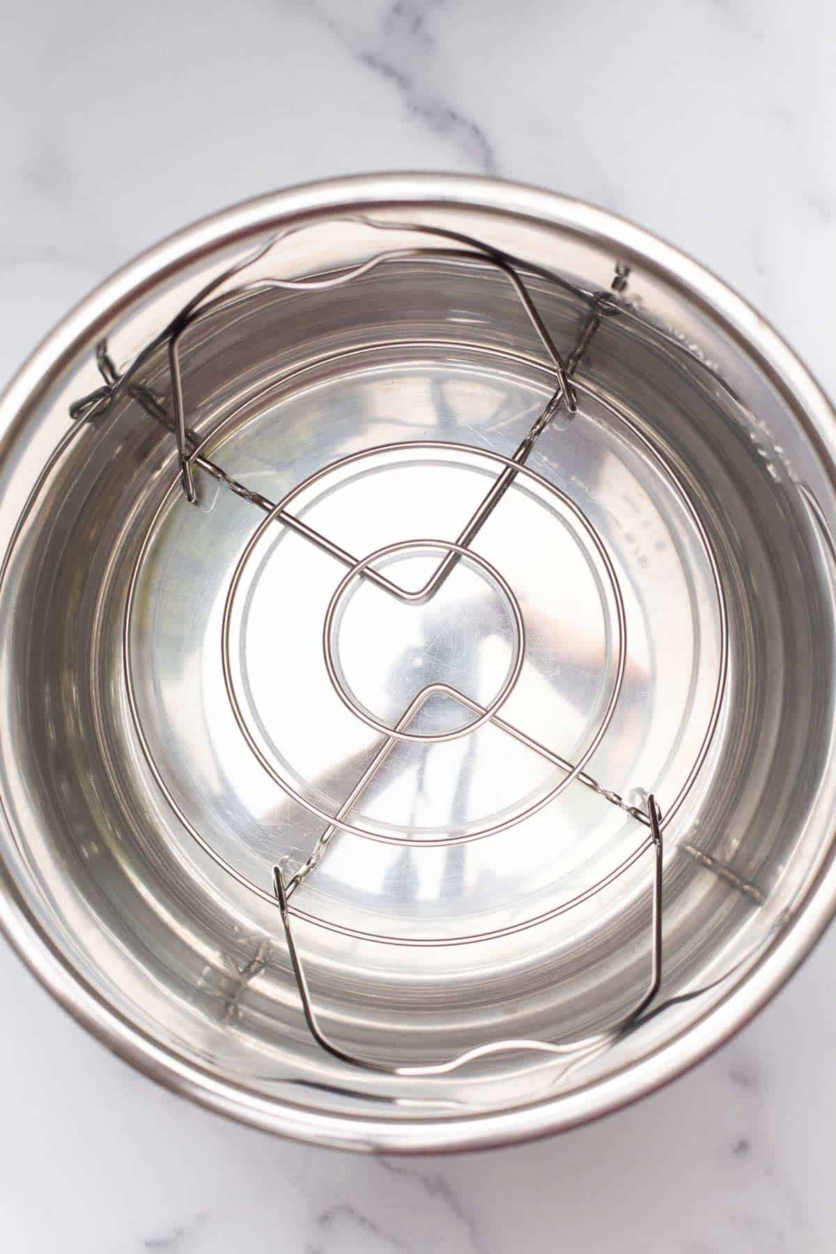 An Instant Pot liner with a trivet placed at the bottom.