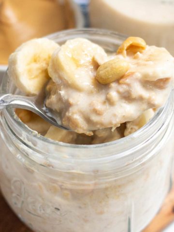 Peanut Butter Overnight Oats in a mason jar with banana slices on top.