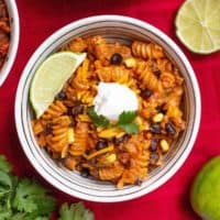 Instant Pot Beef Taco Pasta topped with a dollop of sour cream and a lime wedge.