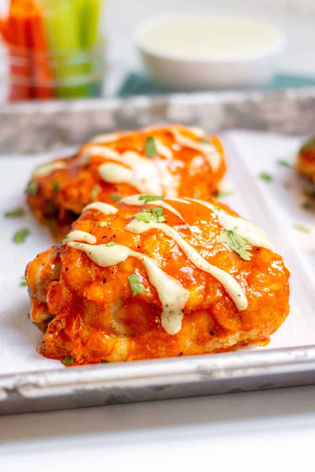 Buffalo chicken thigh with a drizzle of ranch