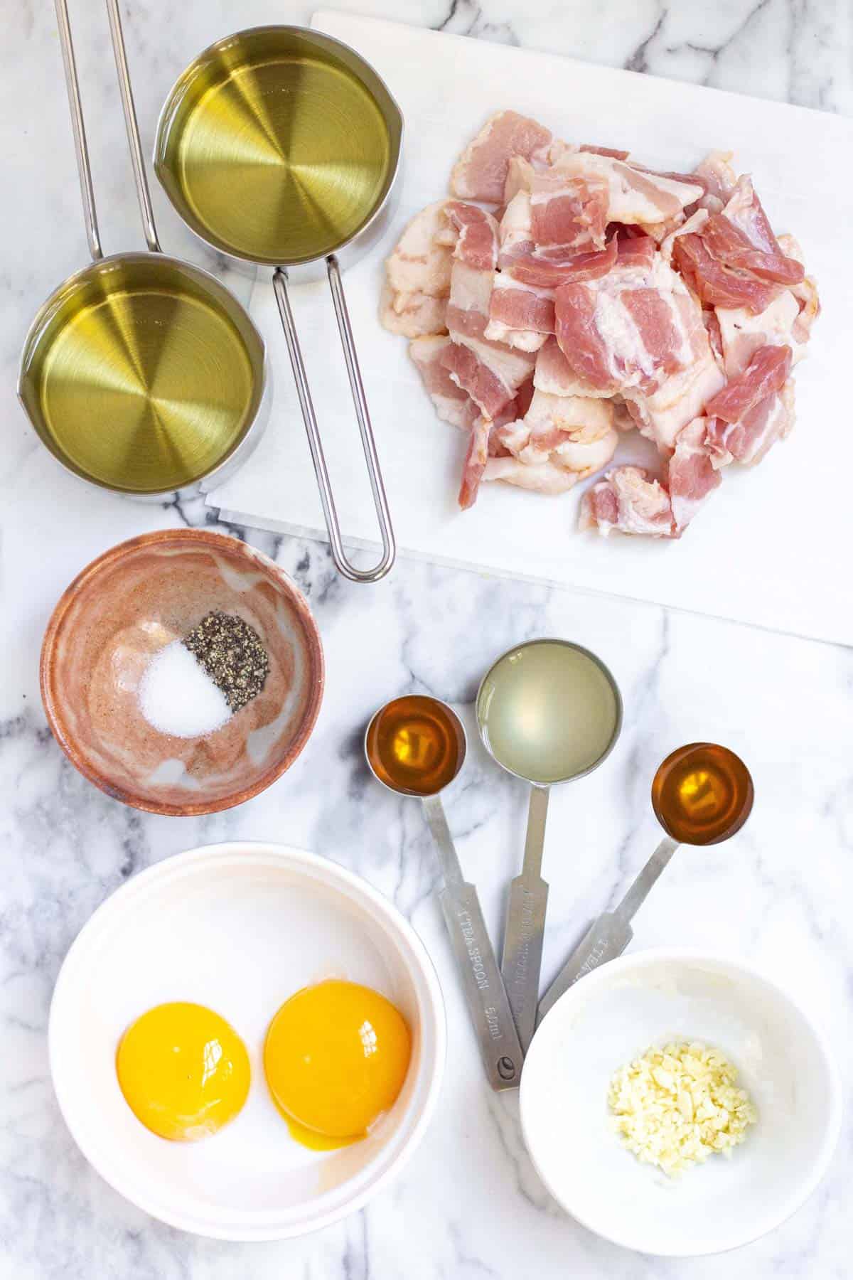 Bacon aioli ingredients: bacon, egg yolks, garlic, honey, lemon, salt, pepper, canola oil.