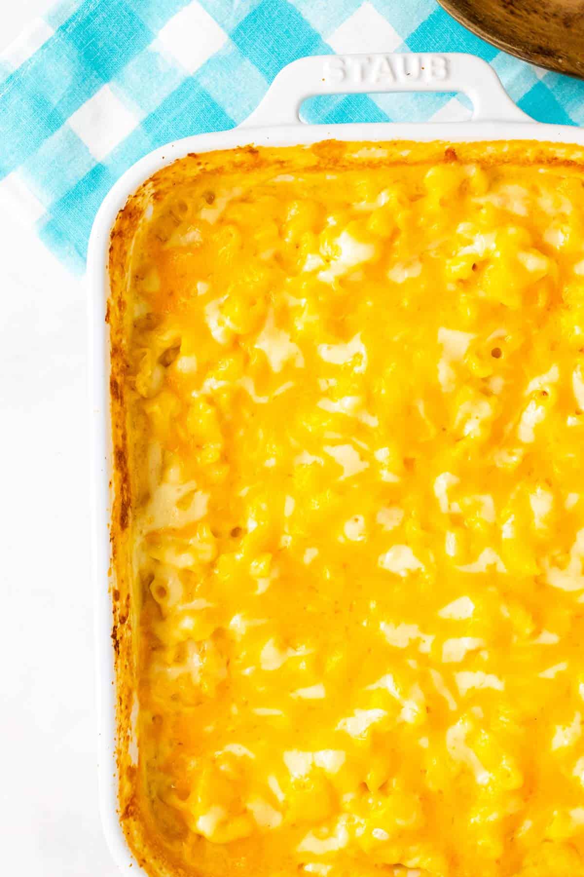 Top-down view of a baking dish filled with baked creamy macaroni and cheese.