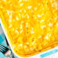 Closely cropped top down view of a baking dish of extra creamy extra cheesy mac and cheese.
