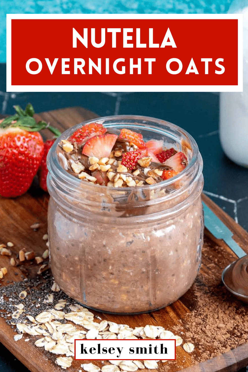 Nutella overnight oats in a mason jar topped with strawberries, Nutella, and hazelnuts. Text at the top of the image says Nutella Overnight Oats.