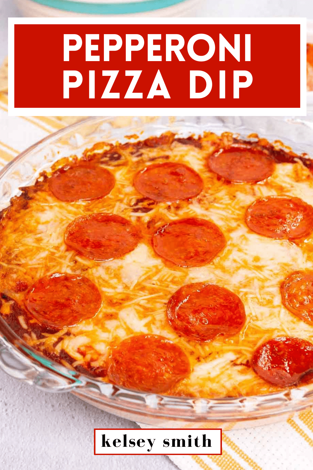 Top down view of pizza dip baked in a pie plate. The dip is topped with pepperoni. Text at the top reads Pepperoni Pizza Dip.