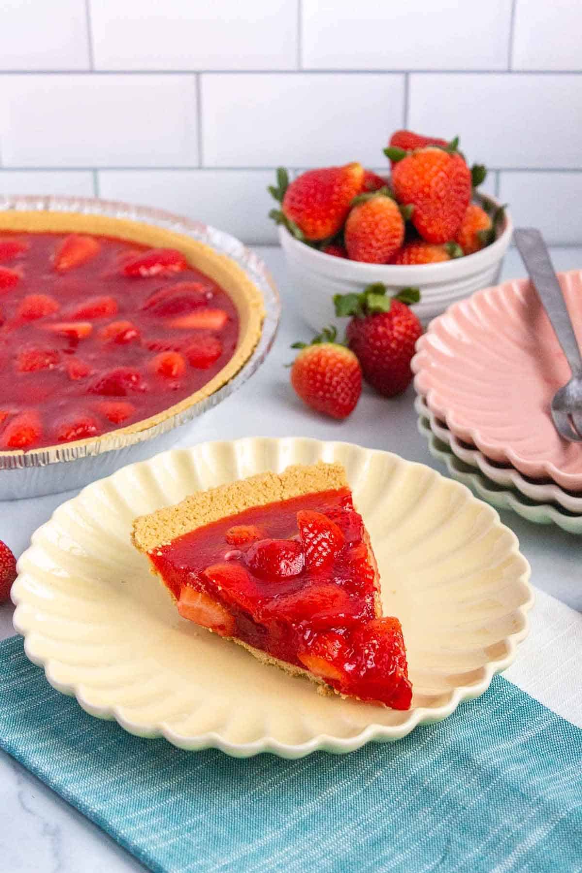 Slice of strawberry jello pie on a small plated.
