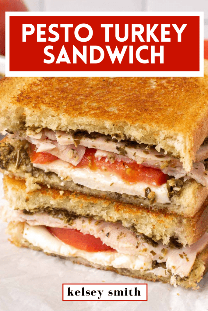 Pesto turkey sandwich cross section with pesto, fresh mozzarella slices, tomato, and thick turkey slices. The sandwich has been grilled and is golden on top. Text at the top reads Pesto Turkey Sandwich.