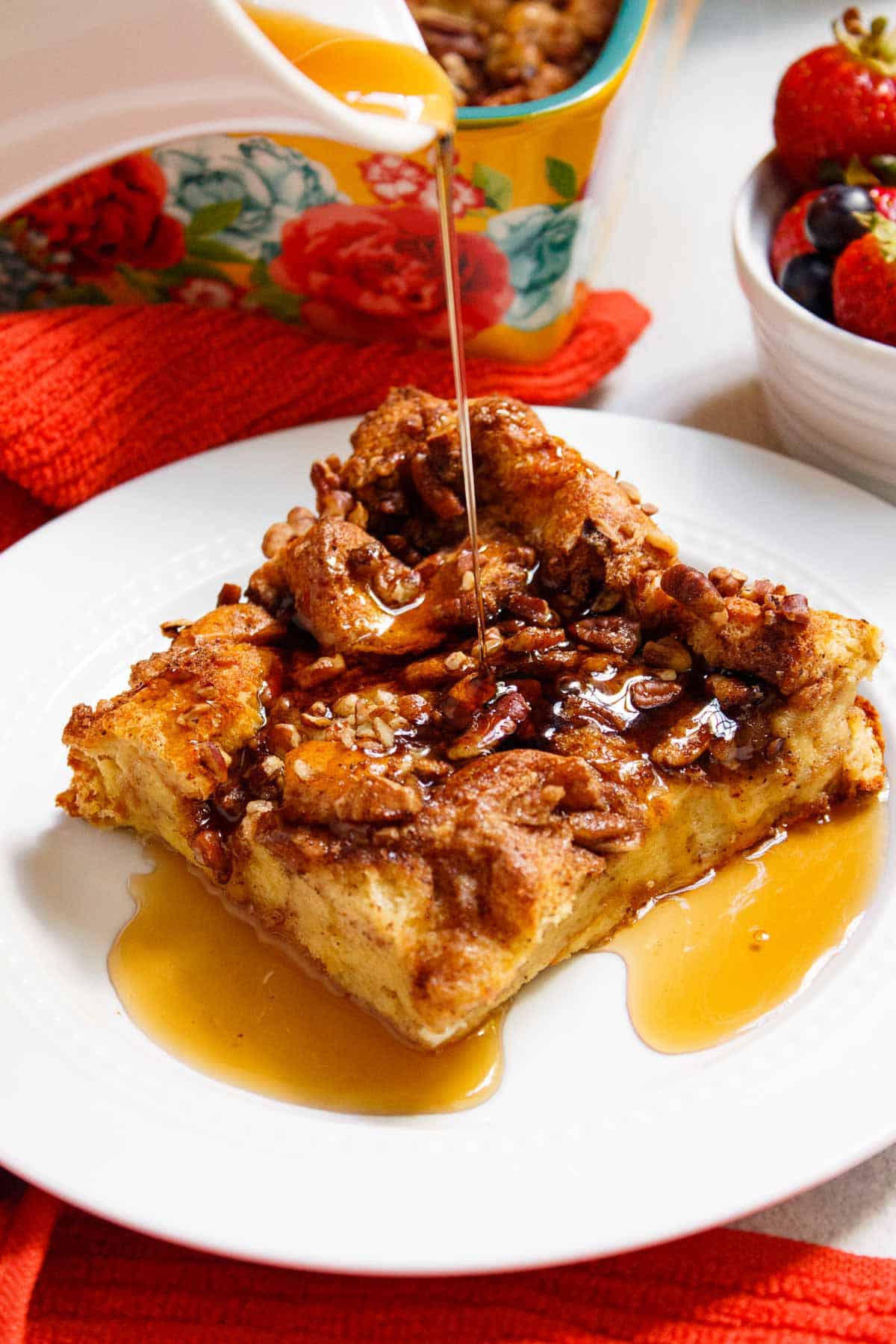 Maple syrup poured over French toast casserole slice.