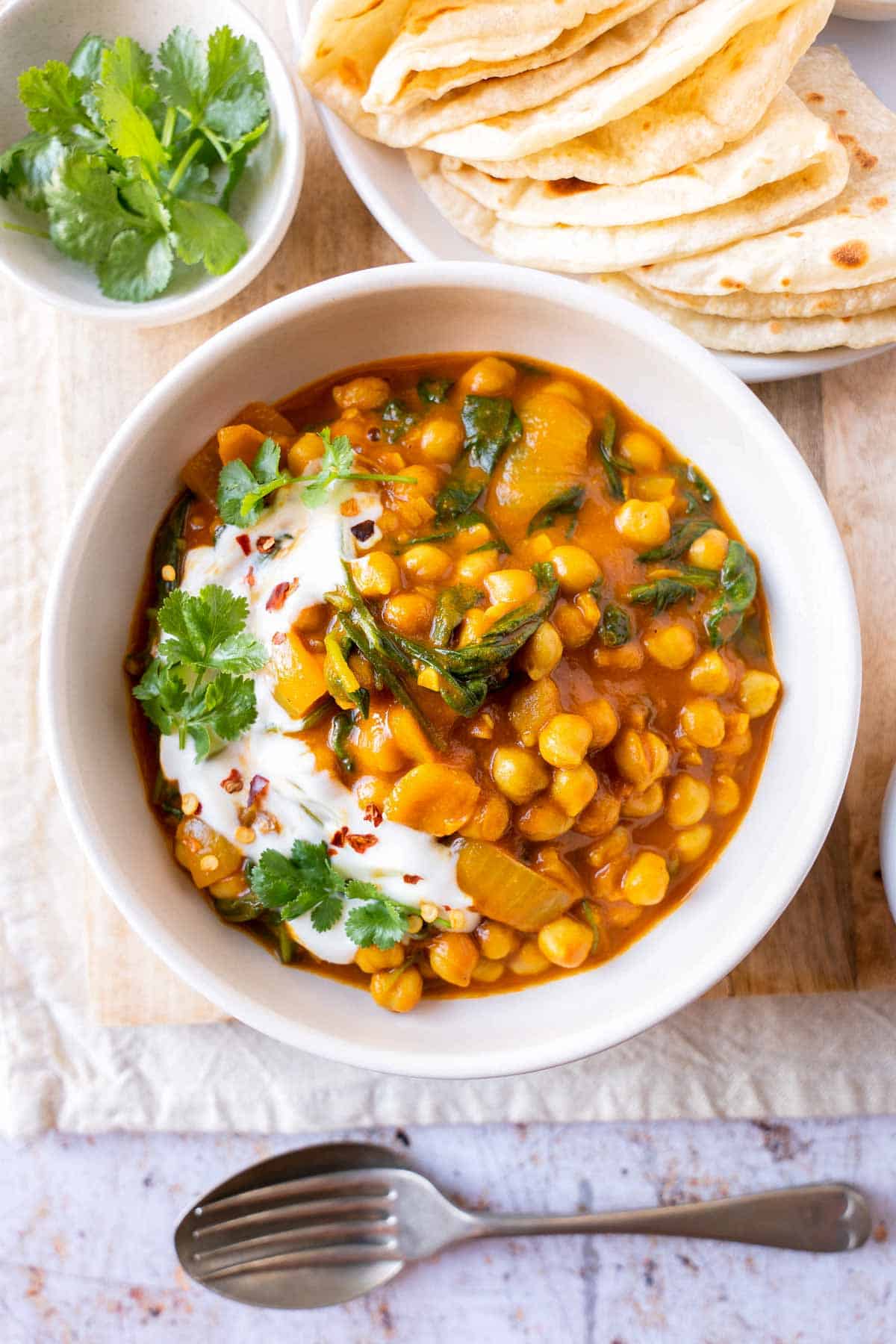 Chickpea and spinach curry served with naan.