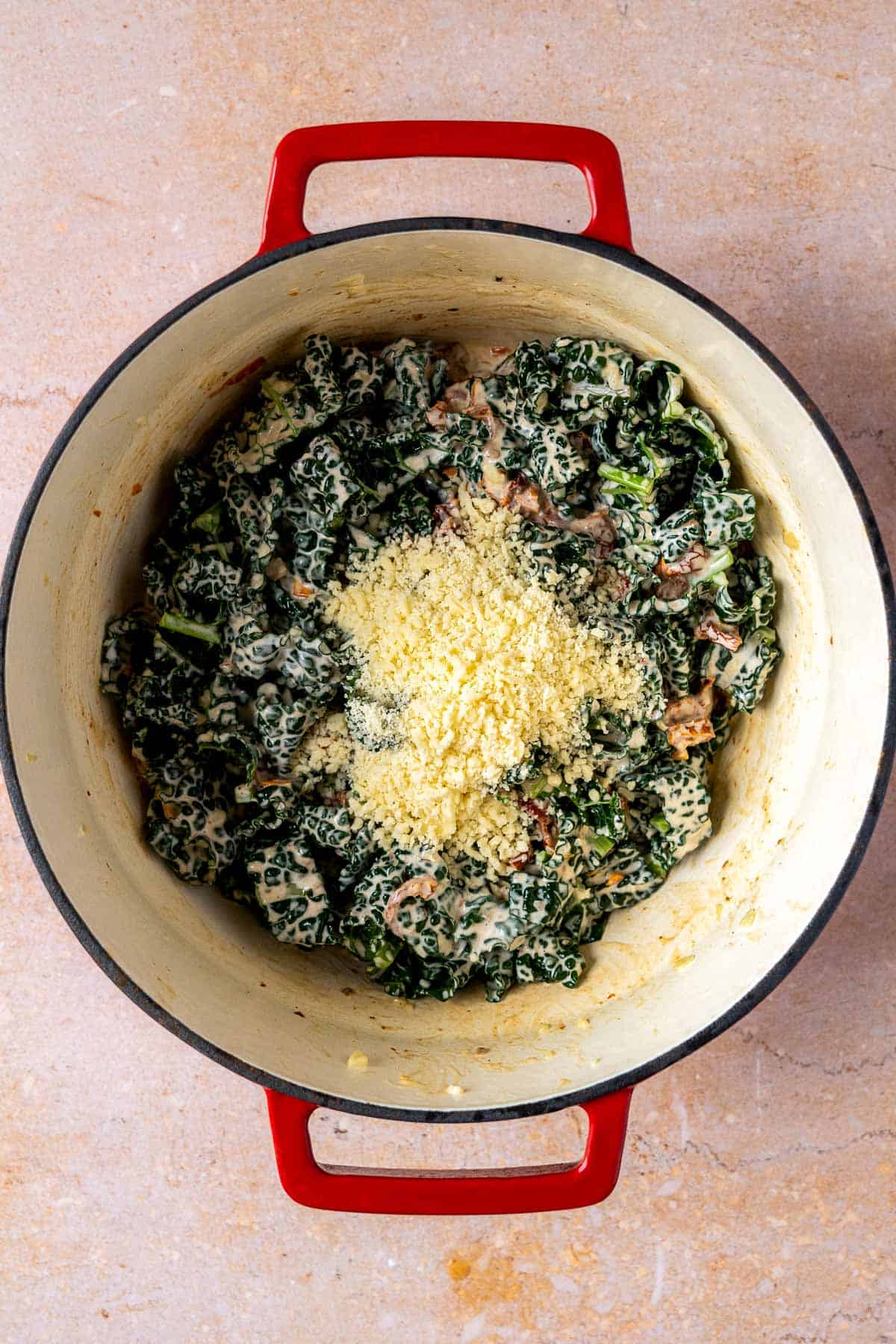 Parmaesan cheese added to cooked kale.