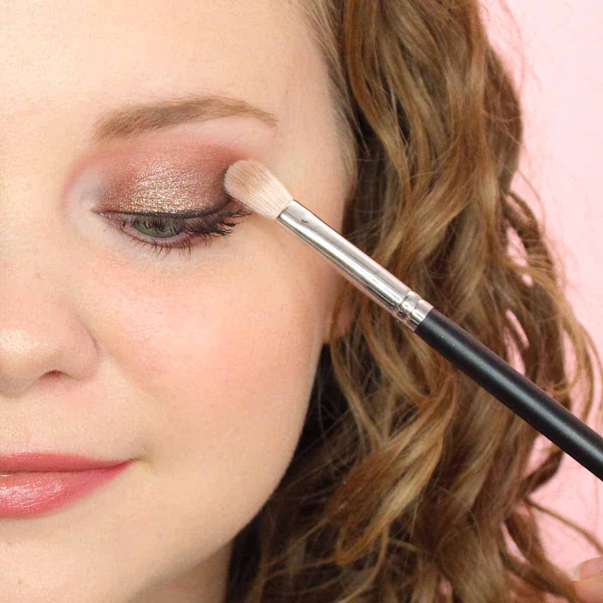 Eye shadow being applied with makeup brush.