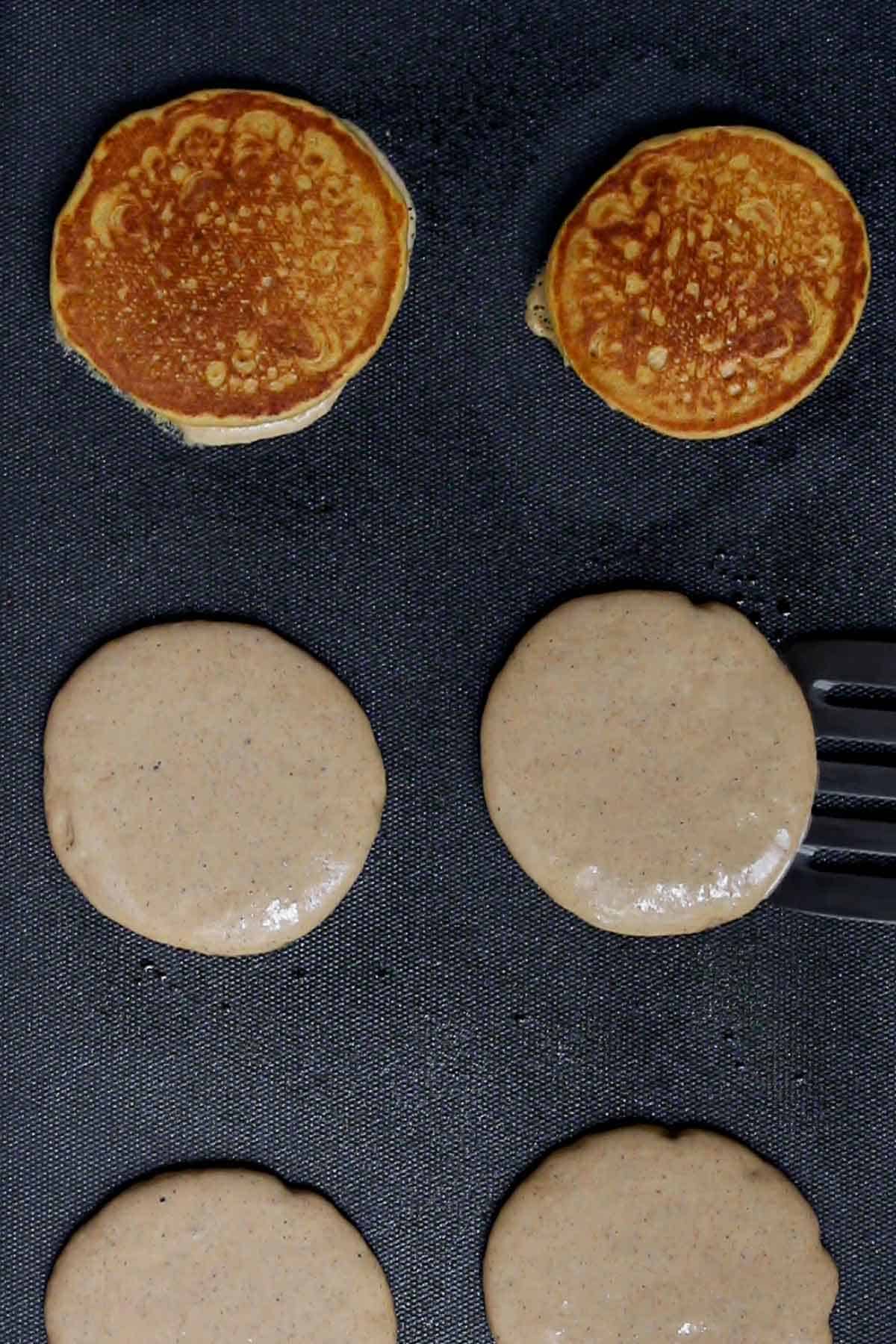 Pancakes flipped when golden on one side.