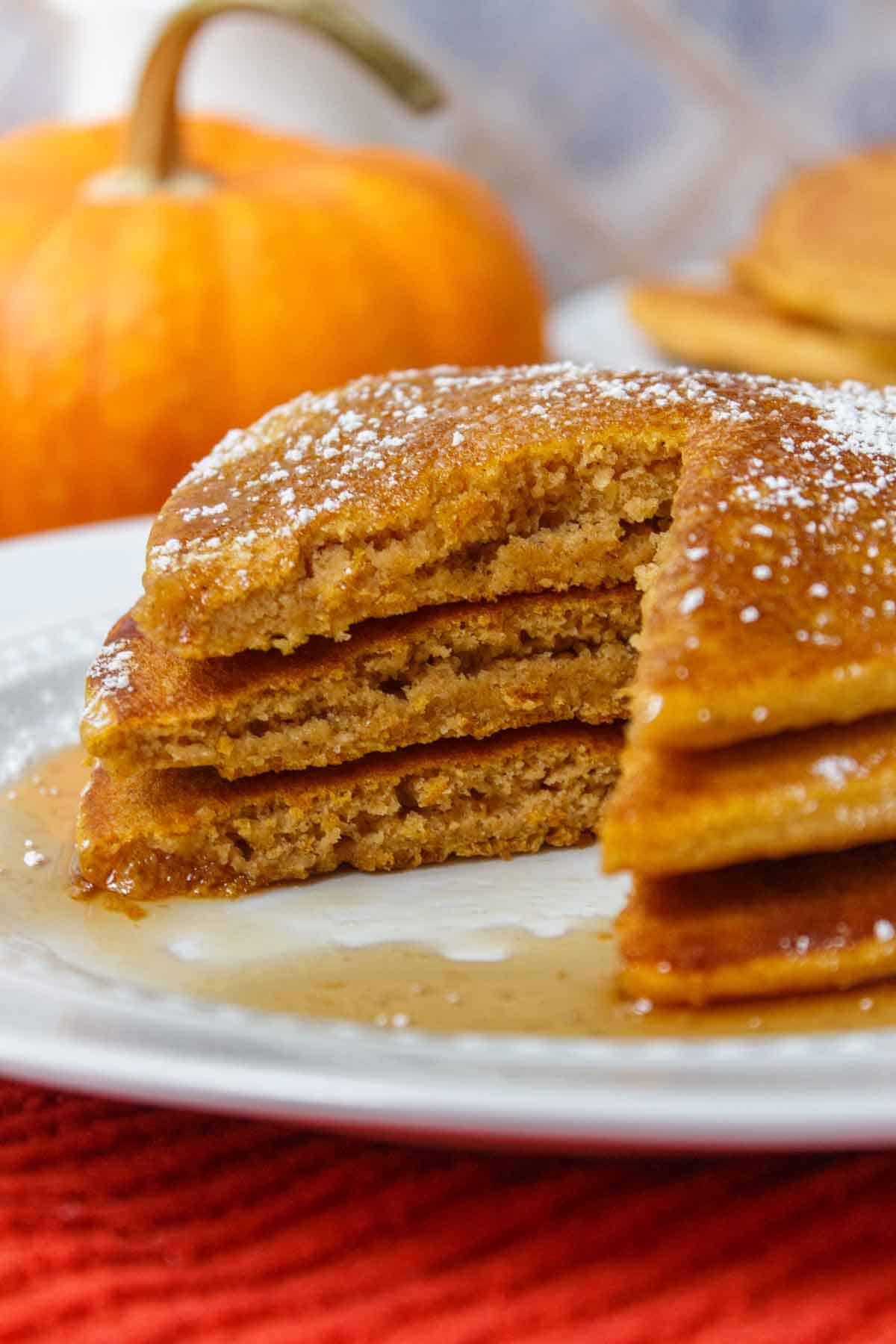 Stack of Bisquick pumpkin pancakes with a bite cut out.