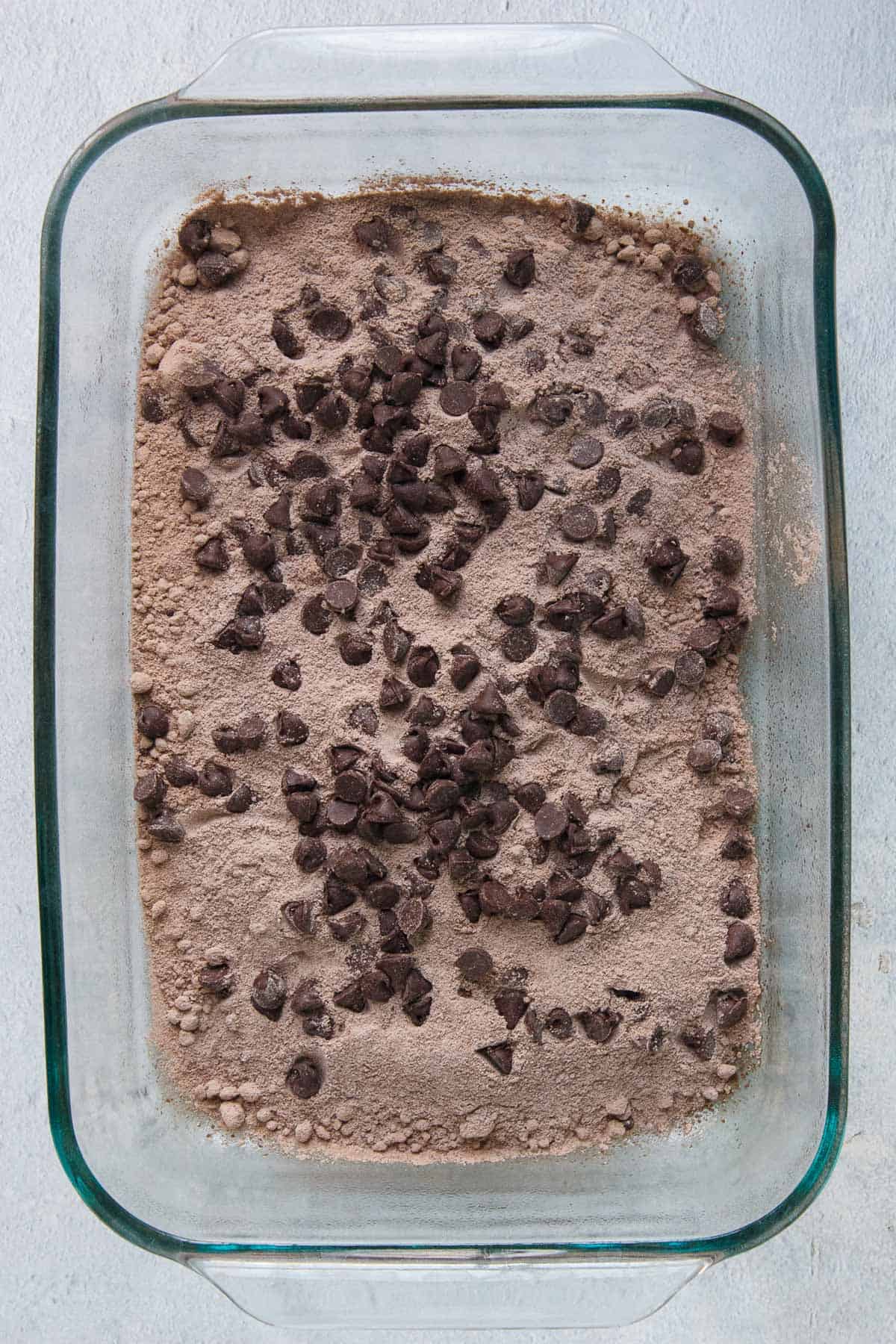 Chocolate chips layered over boxed cake mix and instant pudding mix