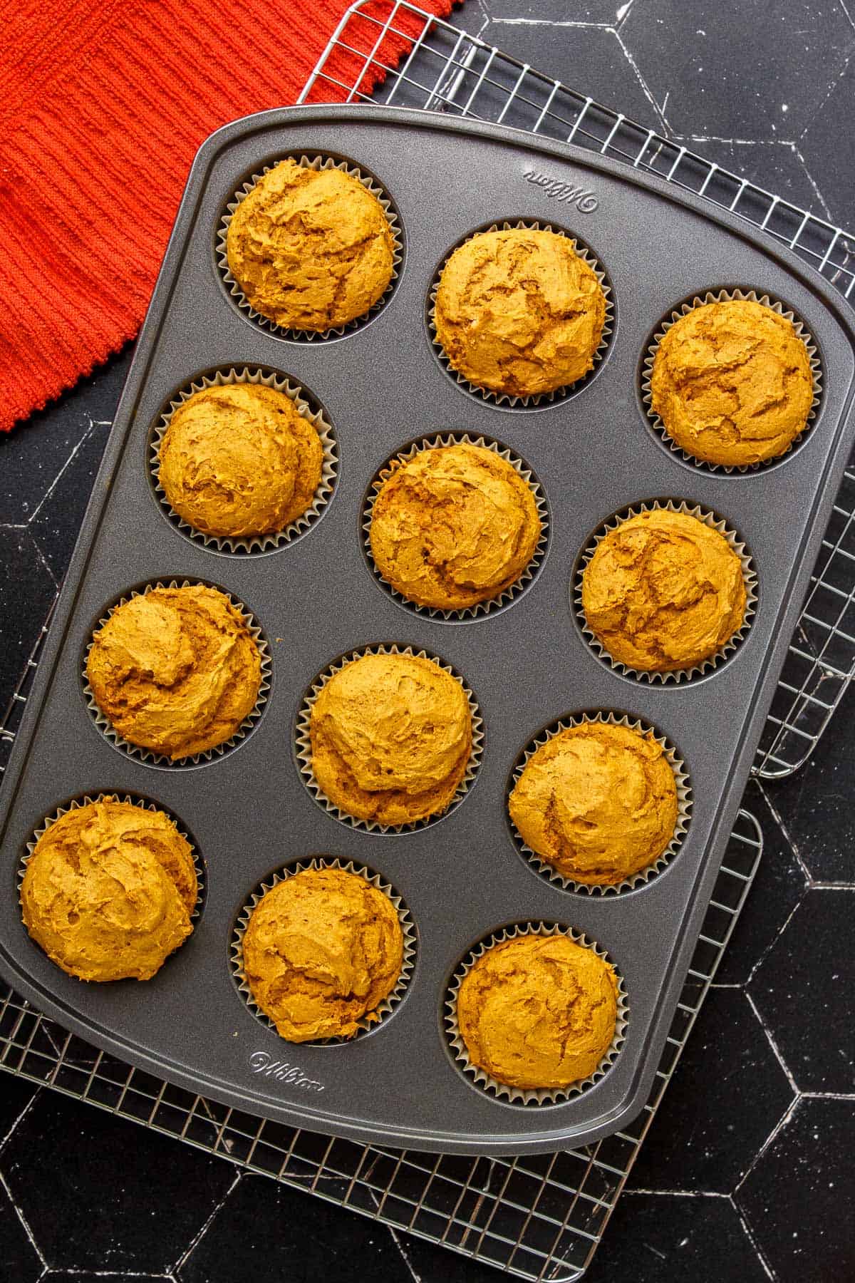 Baked 2-Ingredient Pumpkin Muffins cooling on a wire rack