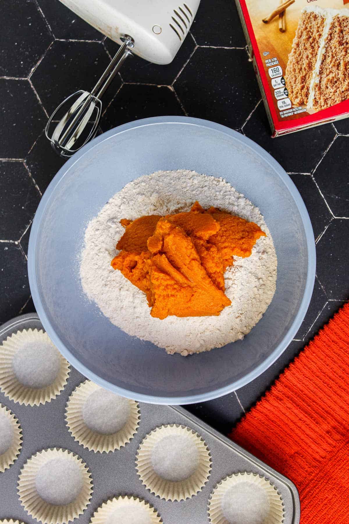 Spice cake mix and pumpkin puree in a mixing bowl
