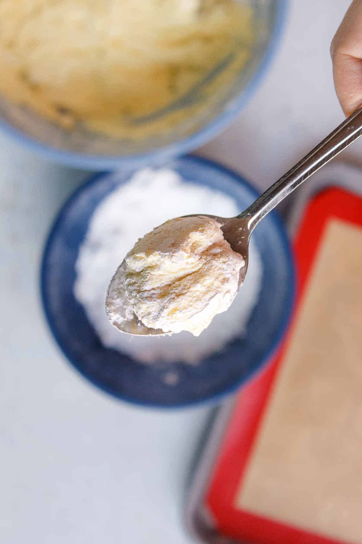 Lemon Cool Whip Cookie dough ball in powdered sugar