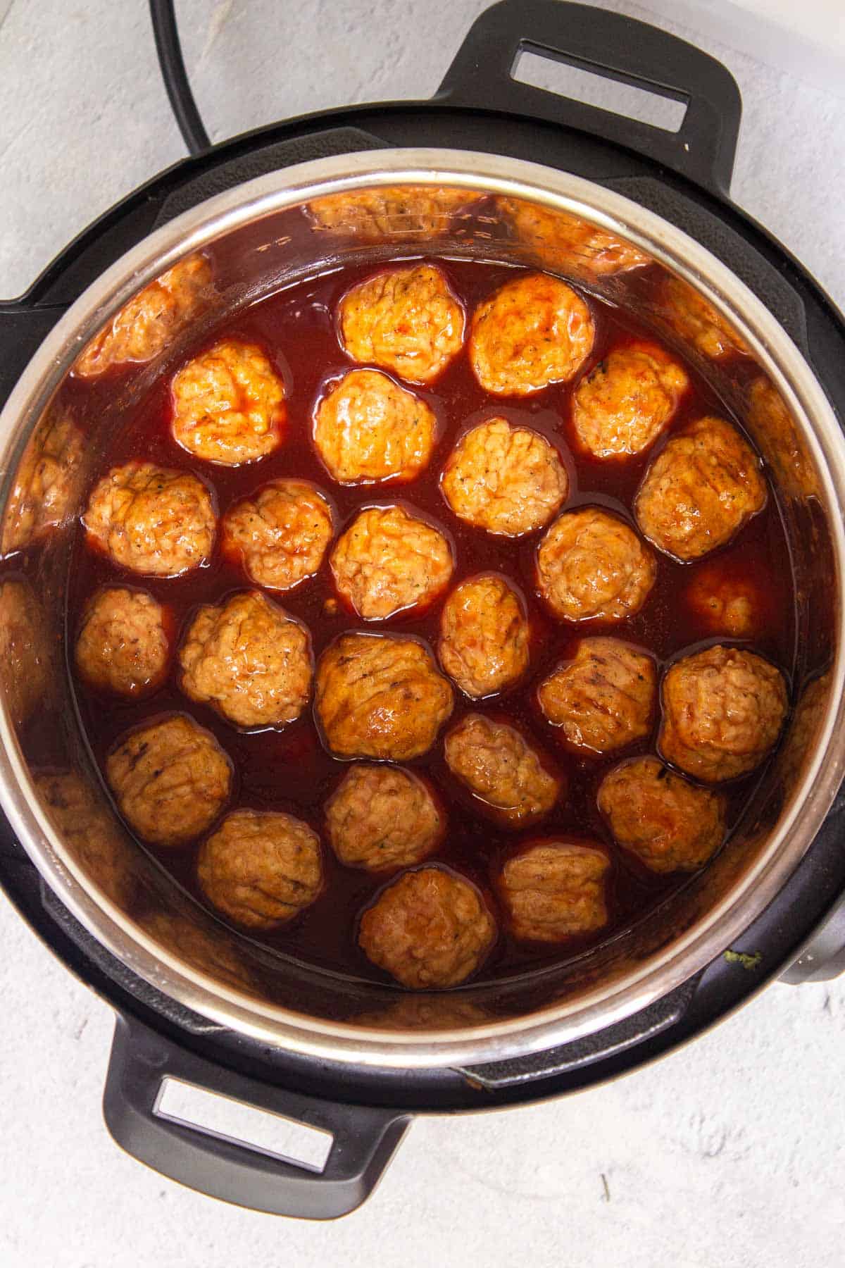 Frozen meatballs in the Instant Pot coated in grape jelly sauce