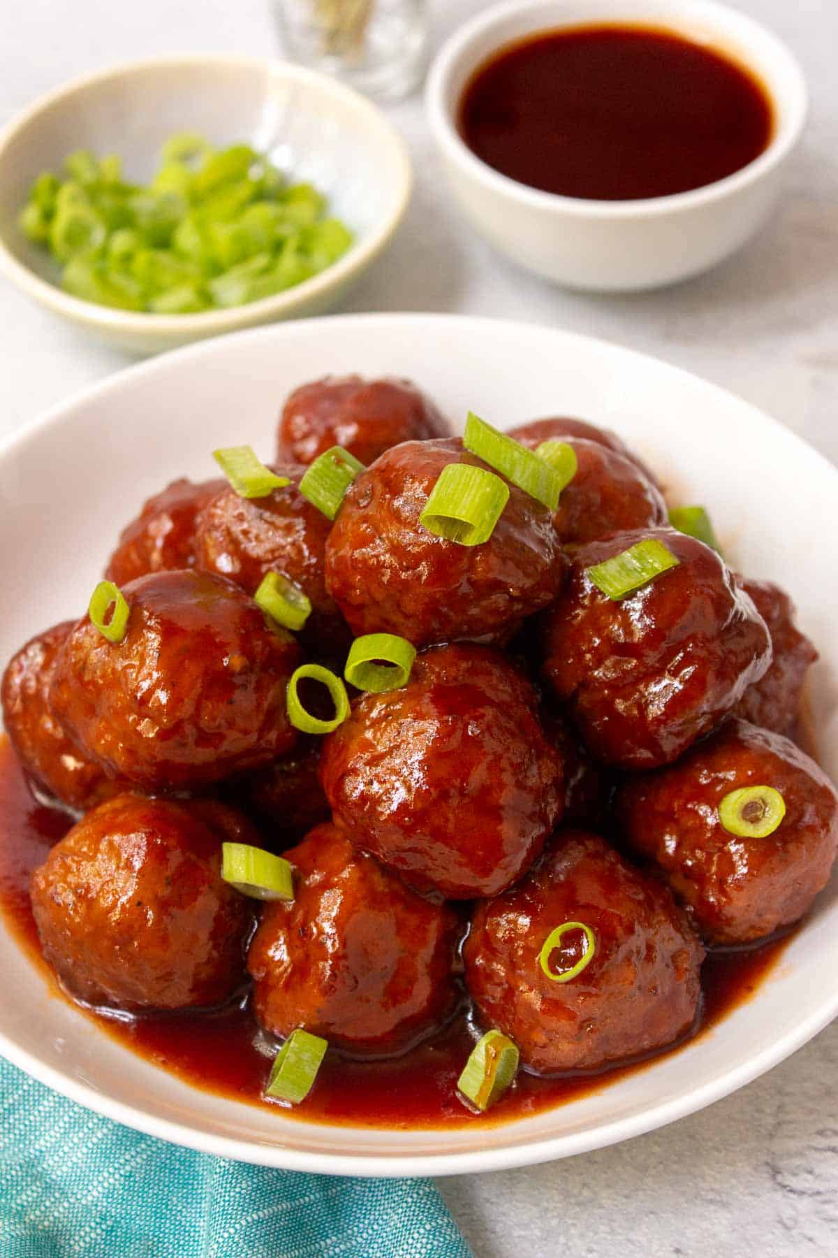 Instant Pot Grape Jelly Meatballs garnished with sliced green onions