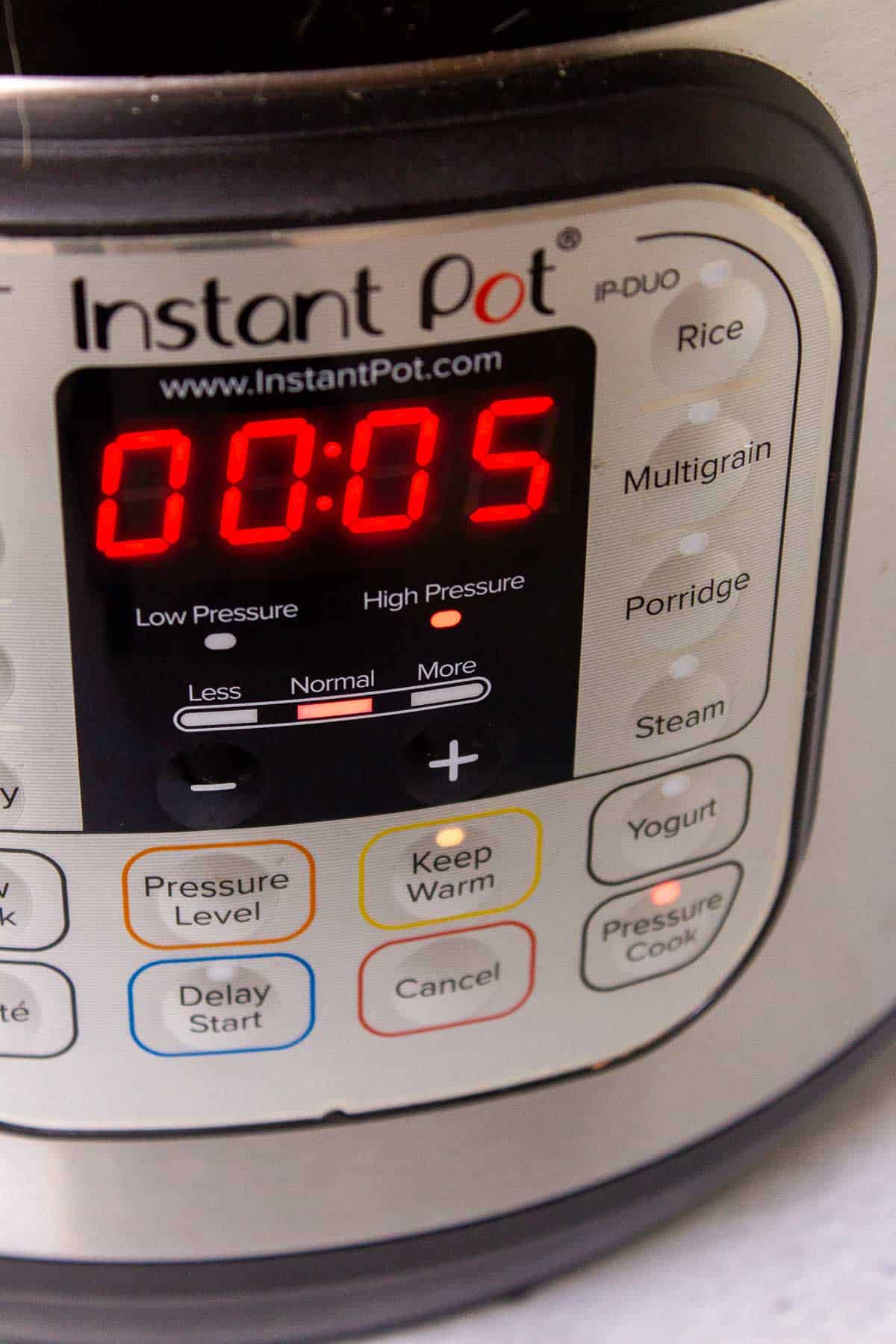Instant Pot display showing the pot is set to pressure cook on high for 5 minutes