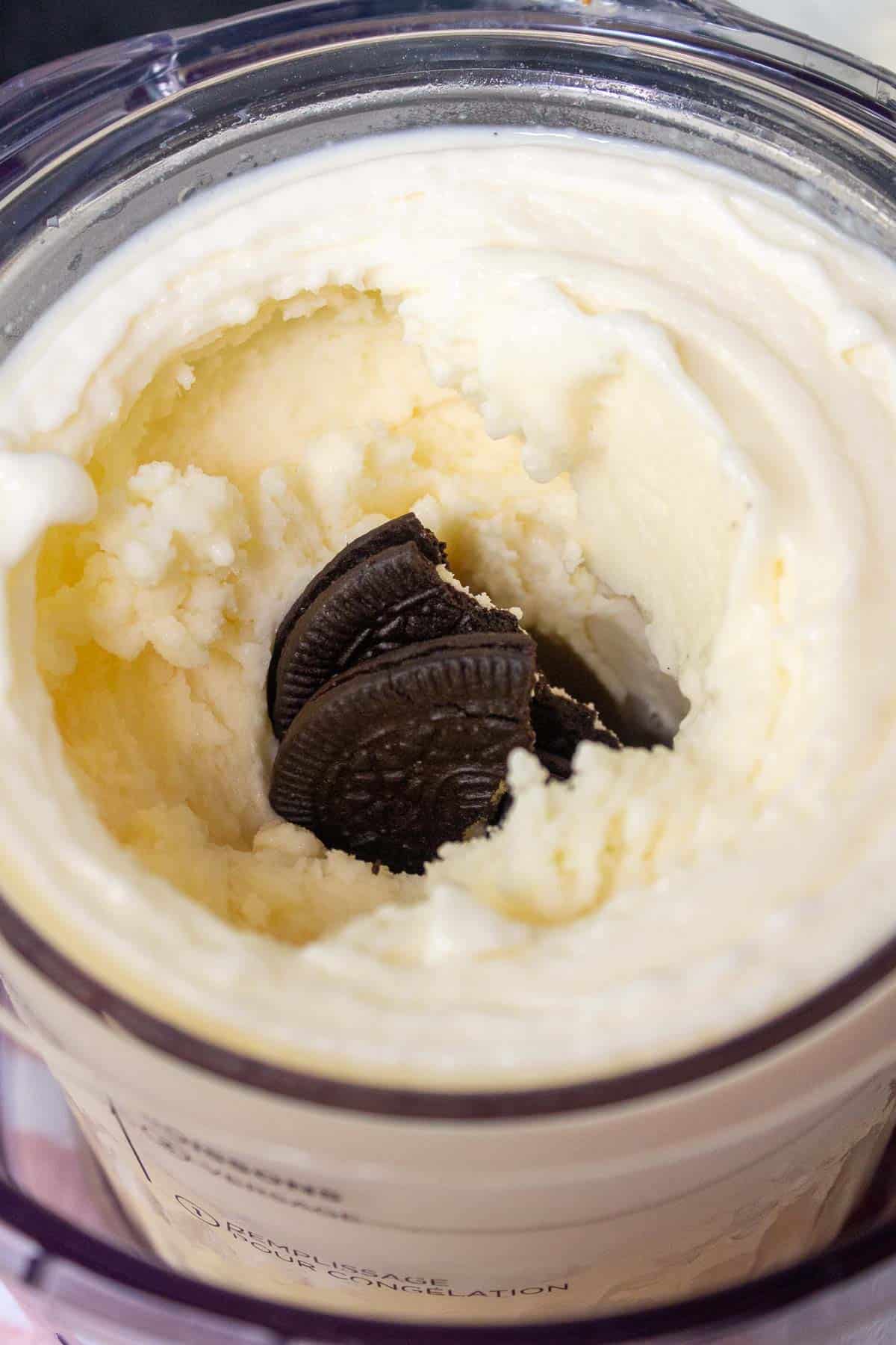 Oreo halves are placed into the hole in the center of the ice cream