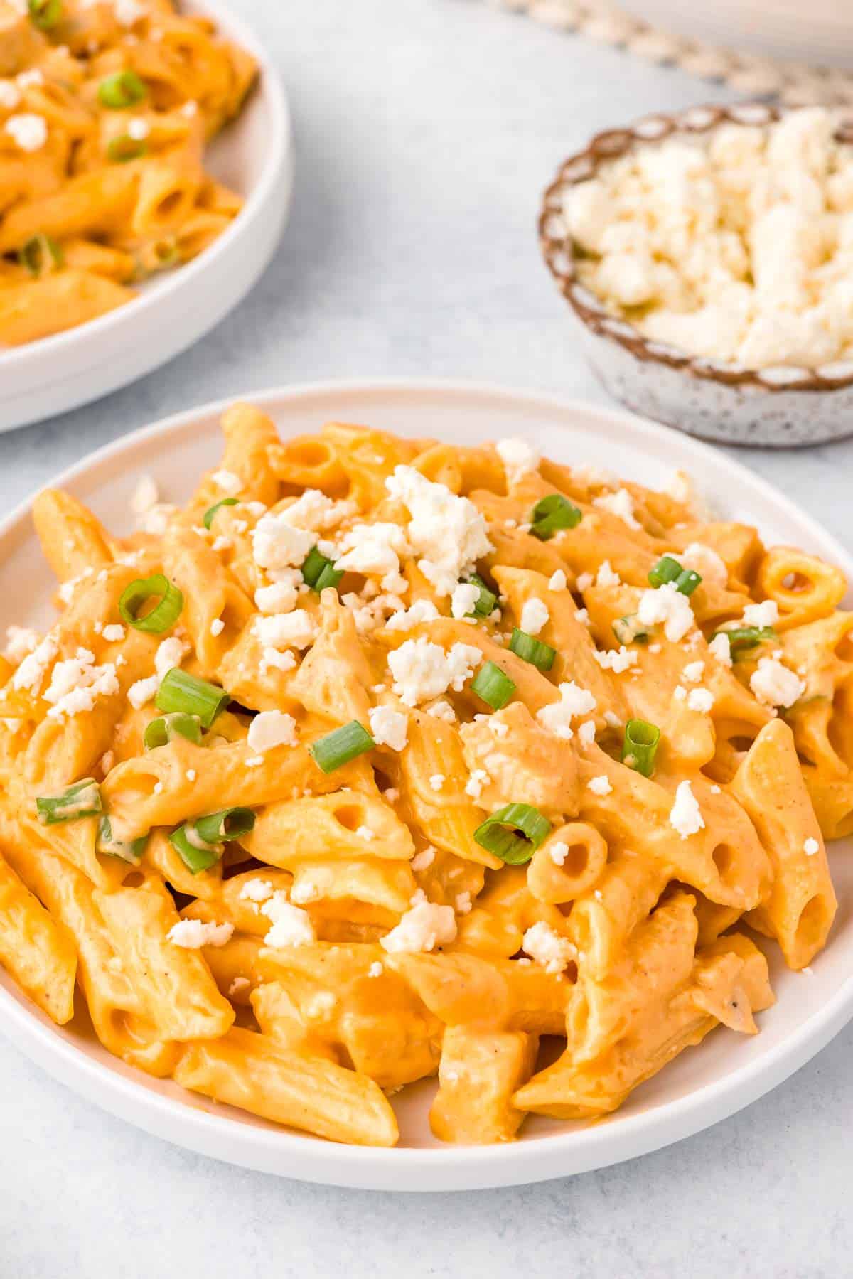 Buffalo Chicken Pasta topped with feta cheese crumbles