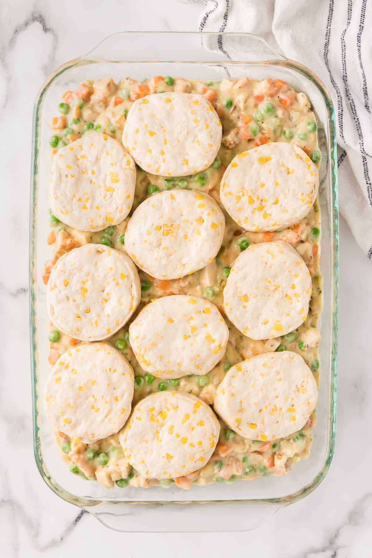 Refrigerated biscuits are evenly layered over the pot pie filling