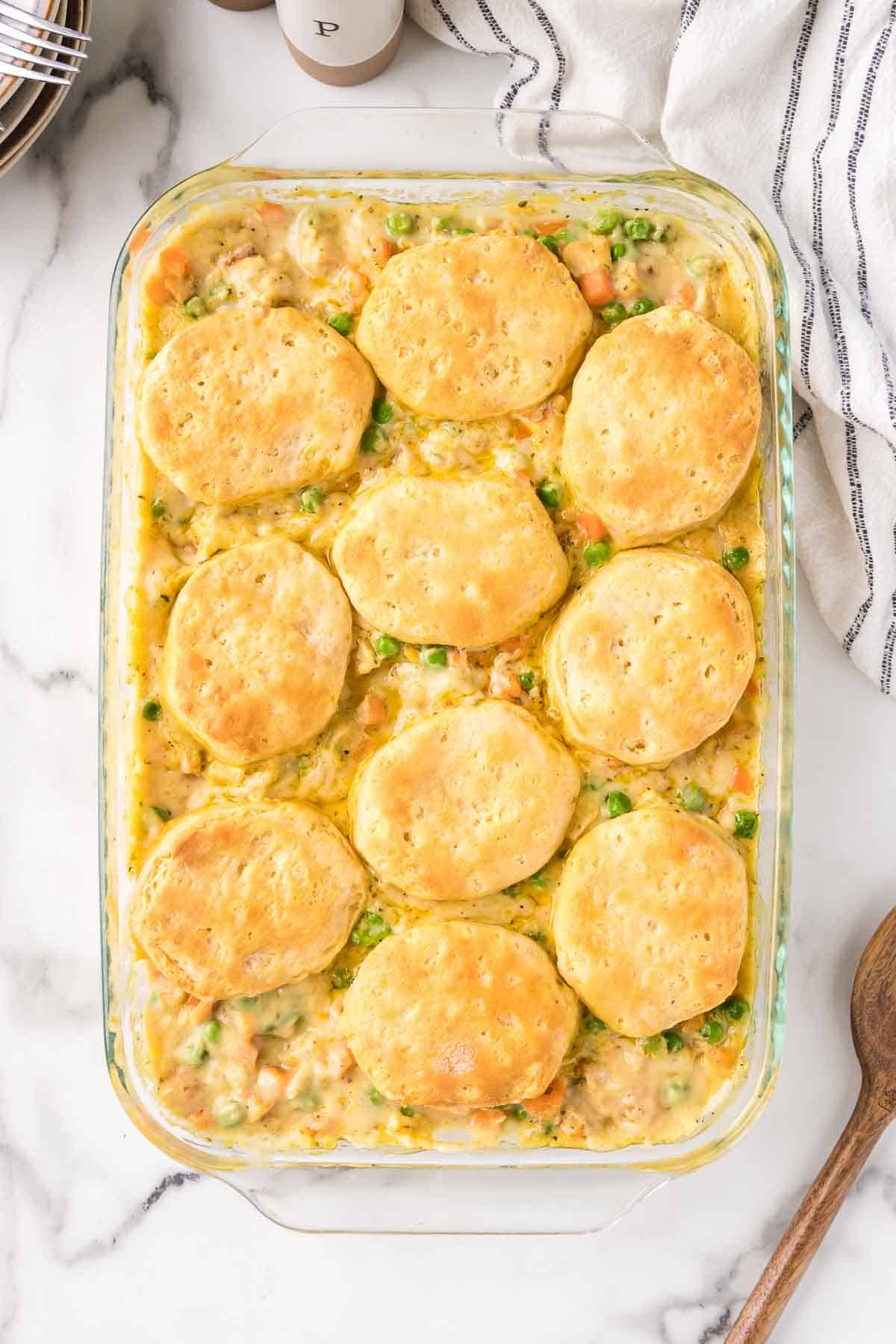 Chicken pot pie casserole is baked until the biscuits are golden