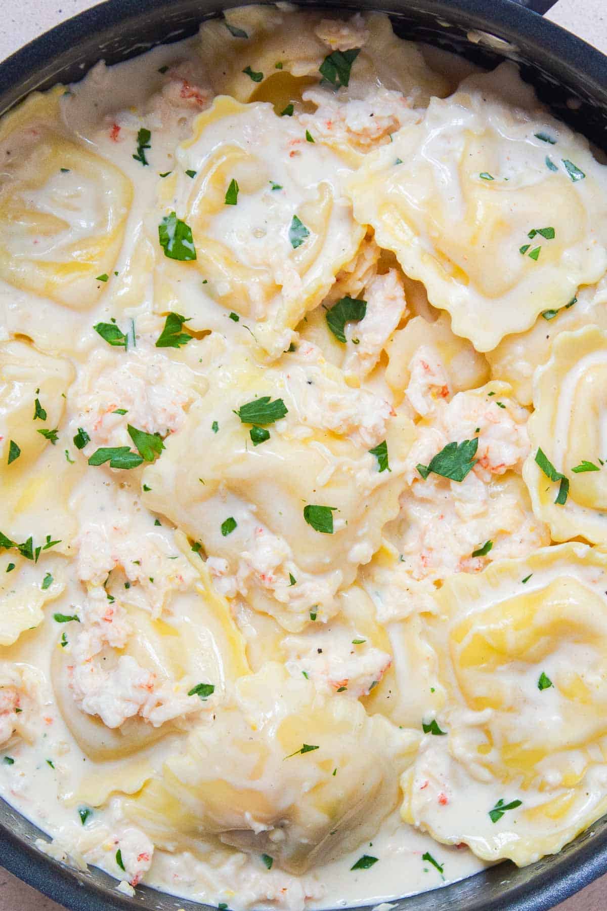 Lobster ravioli in a creamy white wine sauce garnished with fresh parsley
