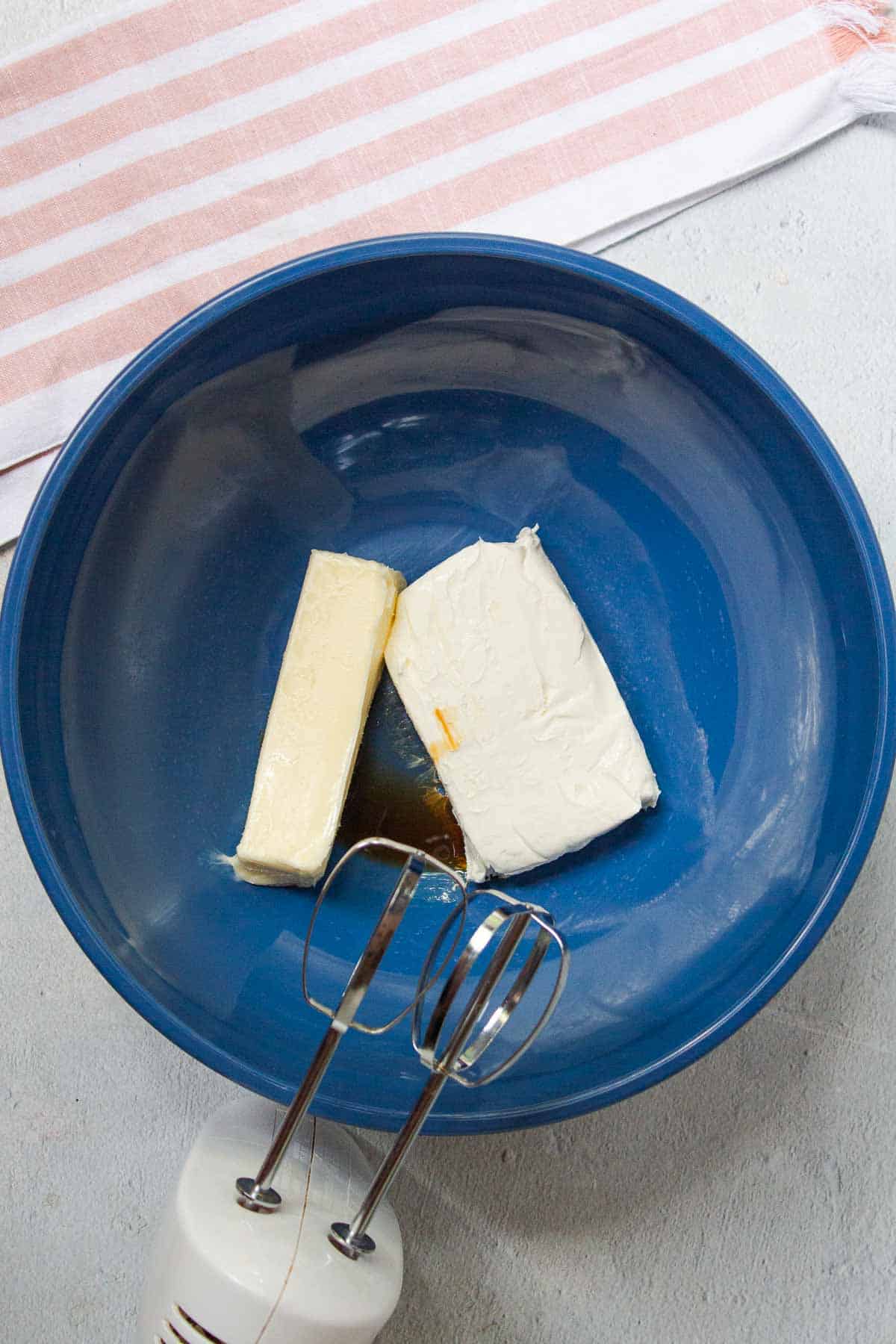 Softened butter, softened cream cheese, and vanilla are added to a large mixing bowl