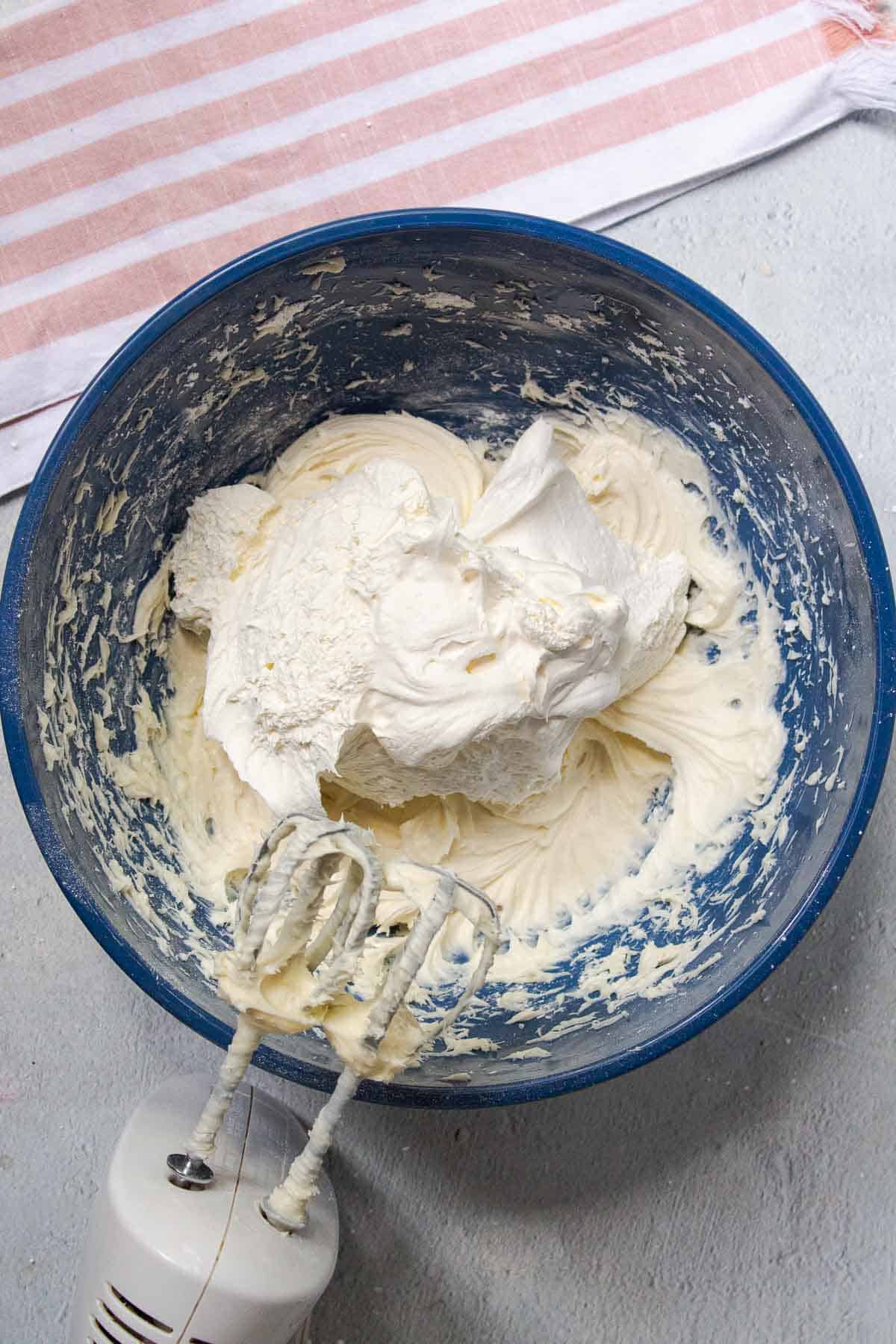 Thawed Cool Whip is added to the mixing bowl