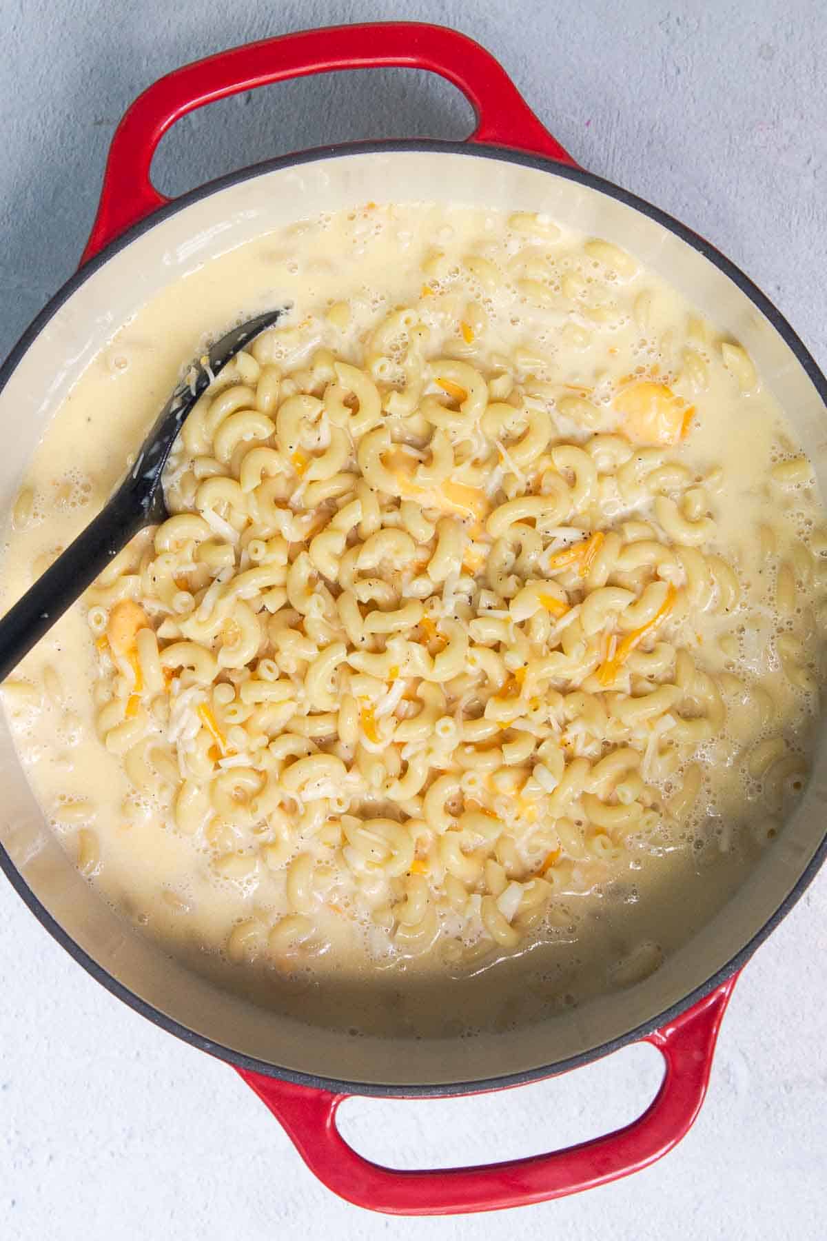 Egg mixture and shredded cheese have been stirred into the cooked elbow macaroni