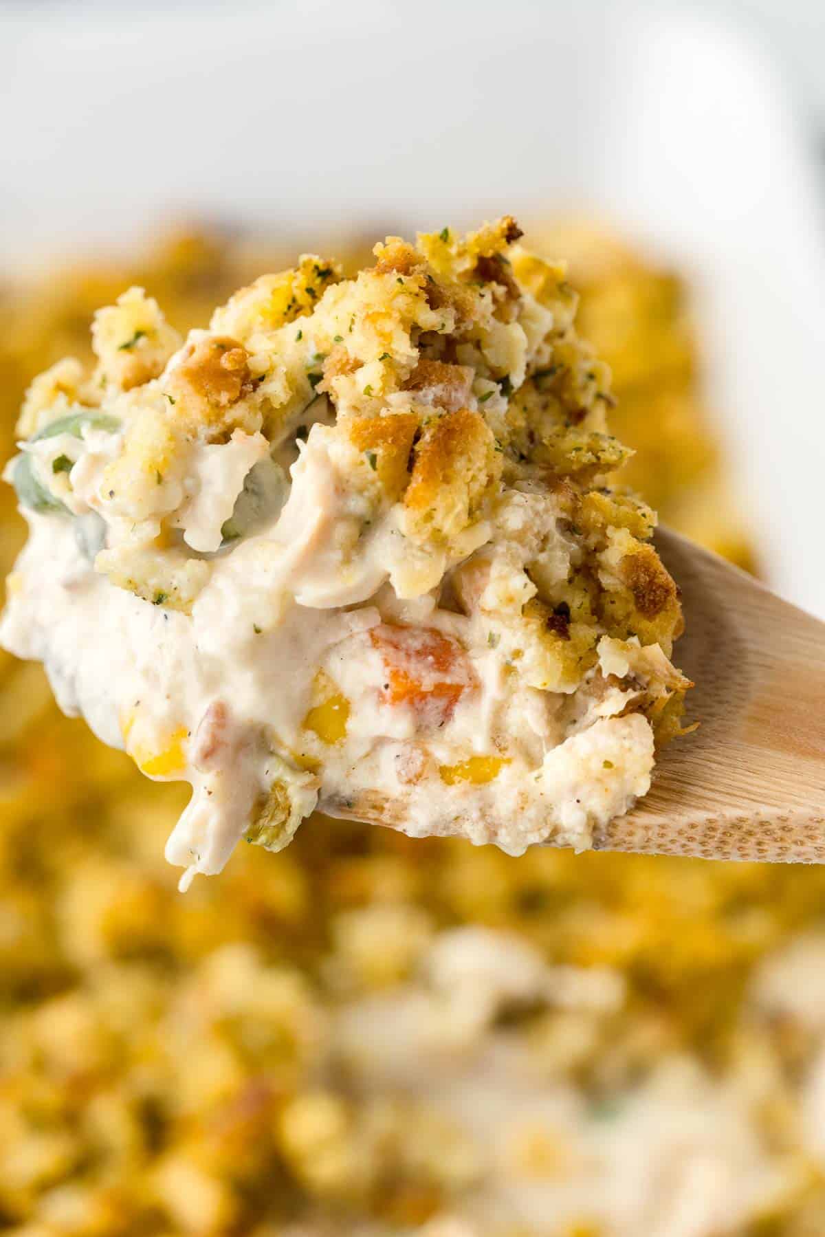 Scoop of Chicken Stuffing Casserole showing the creamy chicken filling and the Stove Top stuffing