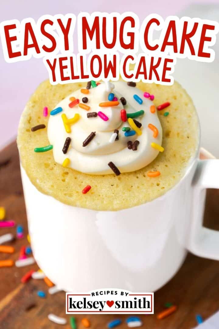 Yellow mug cake topped with buttercream frosting and sprinkles.