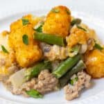 Green bean tater tot casserole with ground beef and cheddar cheese.